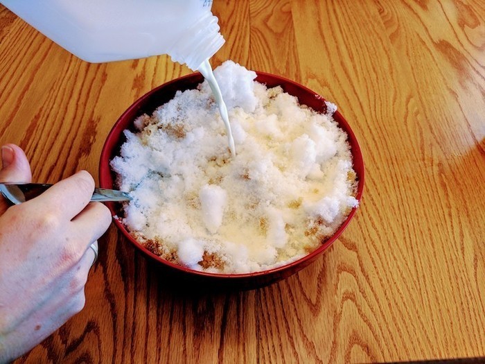 Adding milk to snow ice cream